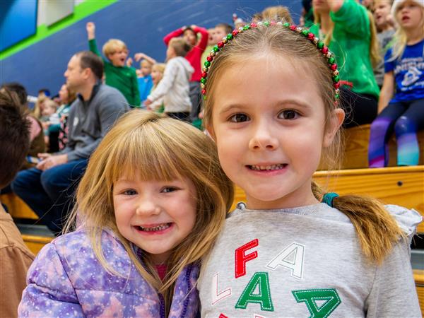 Students in holiday clothes doing festive things at school. 
